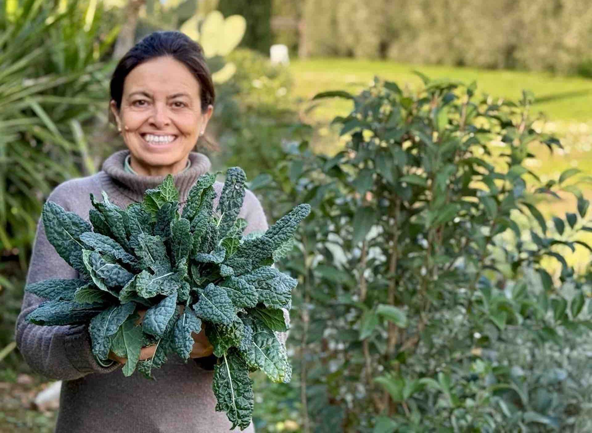 Chicca at Winter garden harvest in Tuscany with fresh herbs and greens